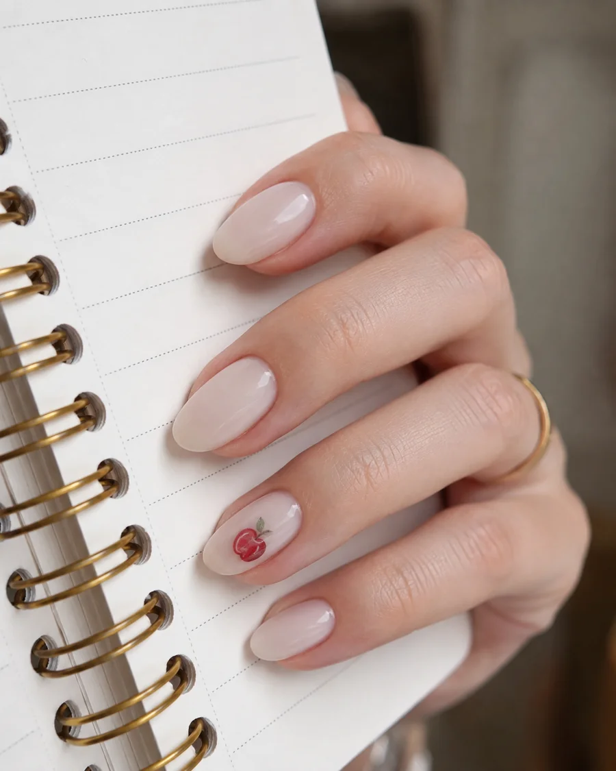 Milky nails with mini apple accent